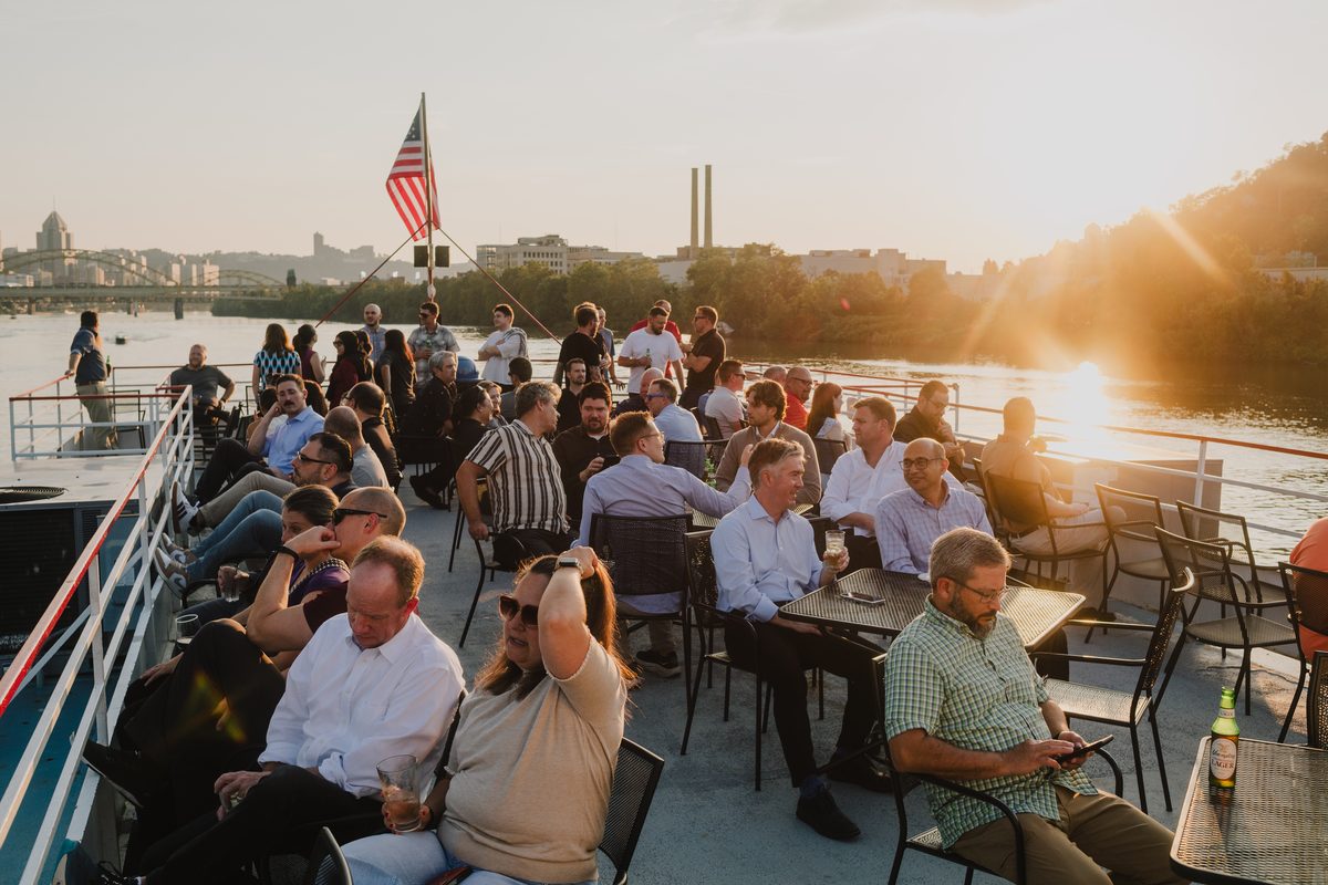 Client Summit 2026 attendees on the deck of the Gateway Clipper at sunset in Pittsburgh